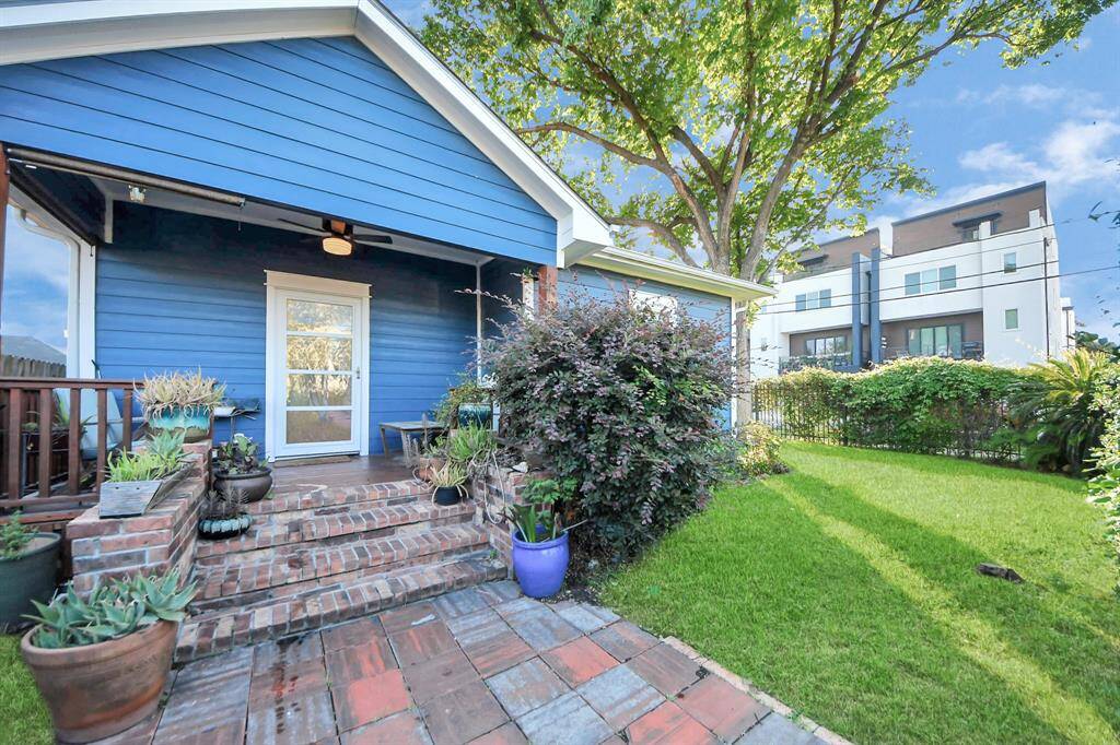 Corner lot! Discover your extra yard space. Decorative pathway leading to the entrance, hinting at thoughtful updates.