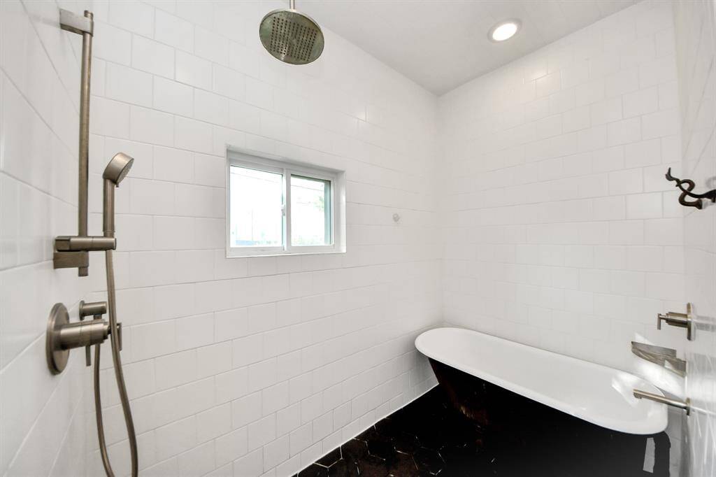 Step into your private spa. The huge walk-in shower features a rainfall shower-head that makes every rinse feel like a retreat. The freestanding clawfoot tub is perfect for long soaks after a busy day.