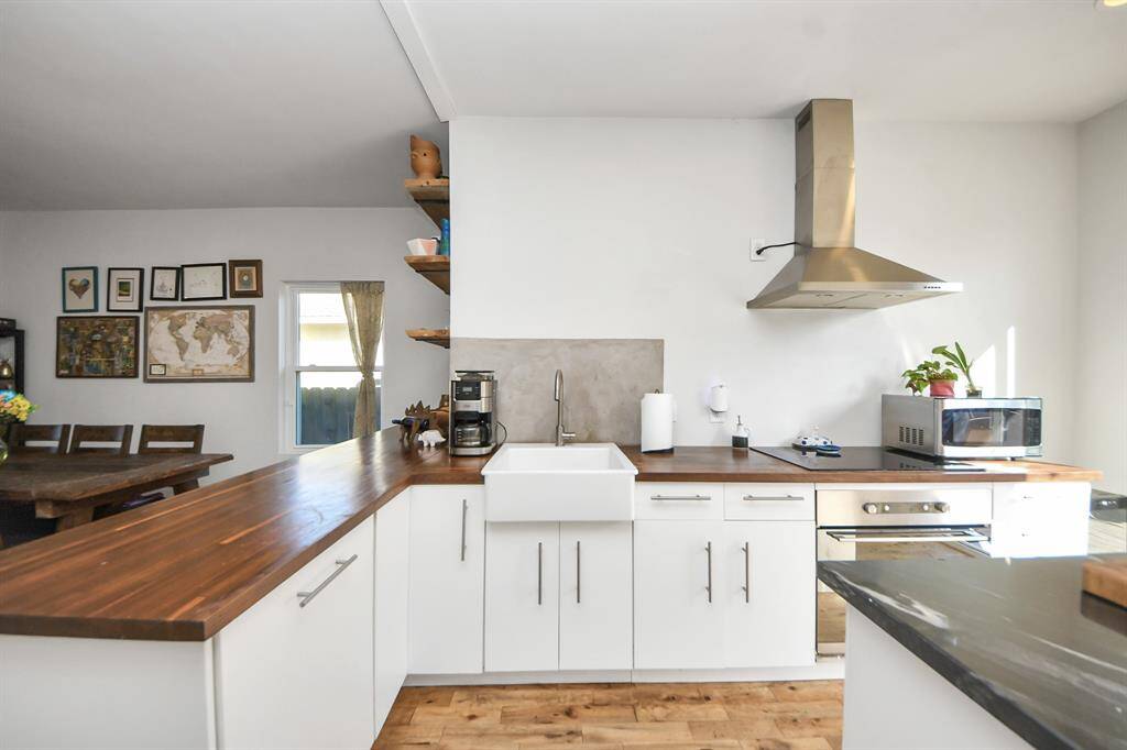 Walnut butcher block countertops and a granite island.