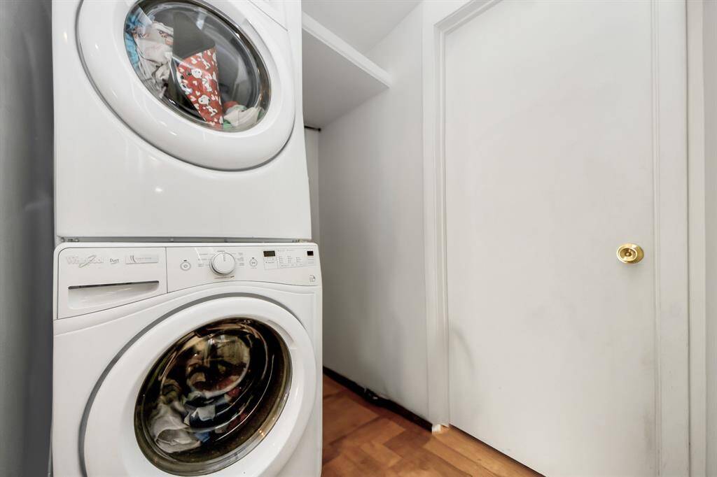 Laundry area with a stacked washer and dryer. Ideal for maximizing space efficiently.