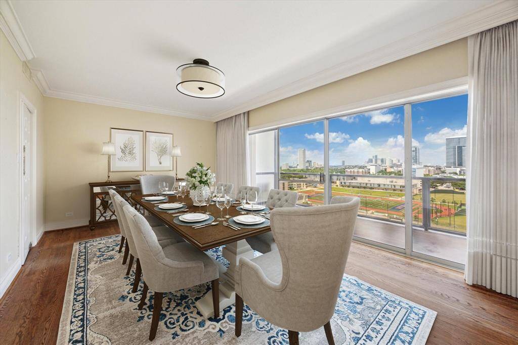 Dining Room with Kitchen to left and Balcony to the right. Virtually Staged. Light fixture not included.