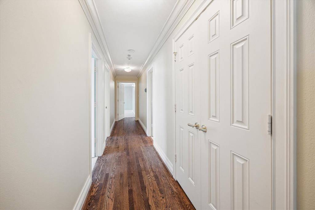 Hallway leading to Bedrooms with storage closet & full bath on right. Secondary bedrooms on left. Primary Suite straight ahead.
