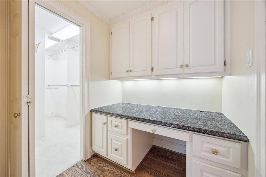 Primary Vanity area with ~6 ft wide granite countertop and under-cabinet lighting. Could be used as desk nook.