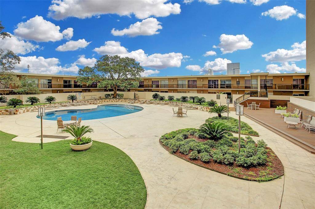 Outdoor Pool with plenty of lounge chairs & tables.