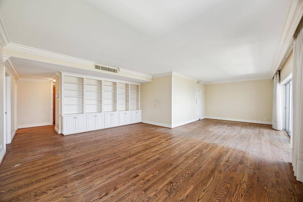 Alternate View of Living & Dining Rooms showcasing entry hall on left and door leading to kitchen from dining on the right.