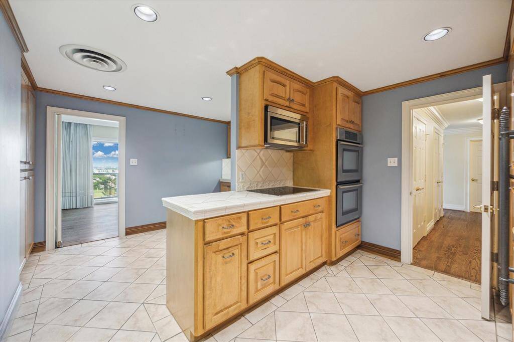 Alternate View of Kitchen with Peninsula and Pantry space on left. Easy access to dining room and entry foyer.