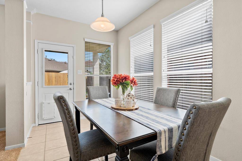This breakfast room with large windows provides a place for casual meals.