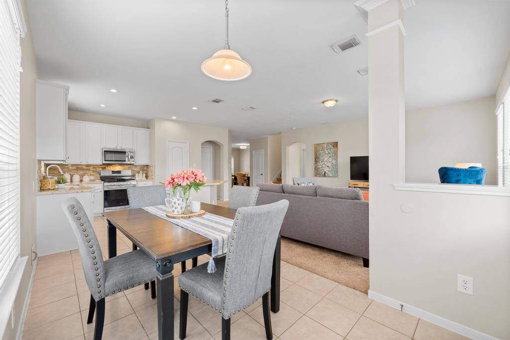 A view of the kitchen and family room from the breakfast room.