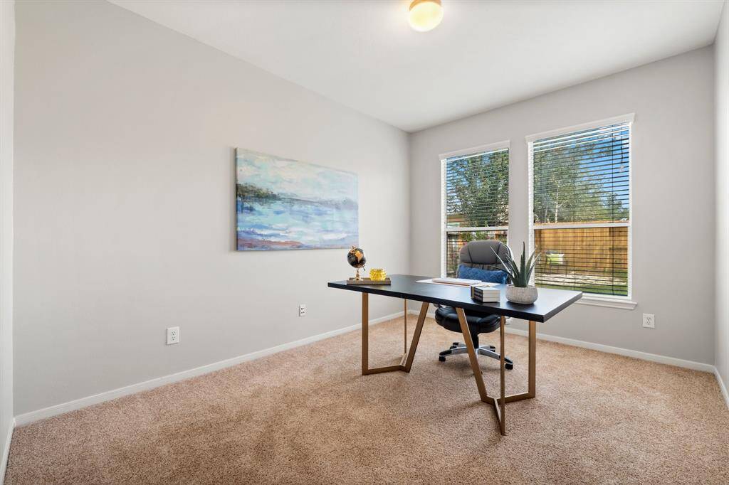 This downstairs flex space with views to the backyard makes a fantastic home office! Also makes a great 4th bedroom!