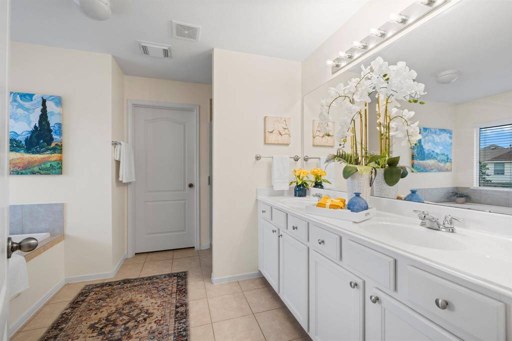 Lovely primary bathroom features double sinks and plenty of storage.