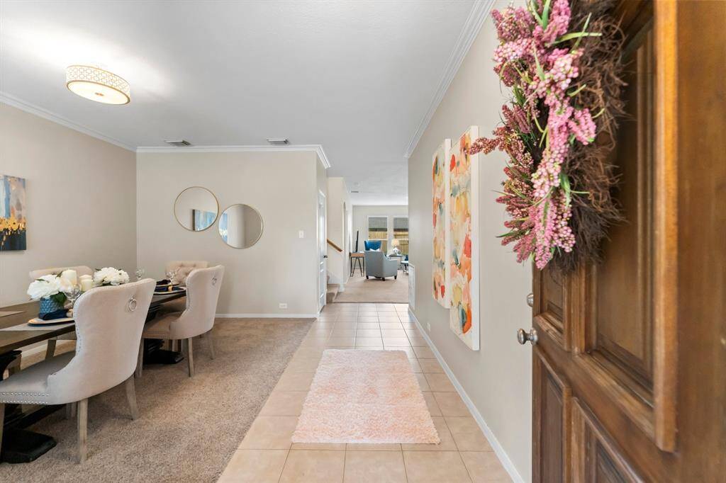 Spacious foyer is light and bright with formal dining/flex space on the left.