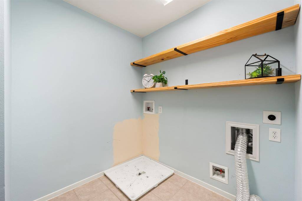Laundry room with shelving is located upstairs near the bedrooms!