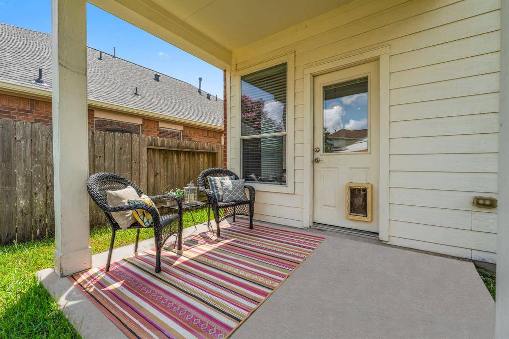 This covered porch provides a place to relax in the shade while enjoying the privacy of your backyard.
