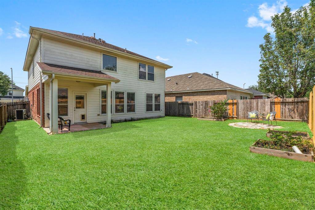 Another view of the backyard and covered porch.