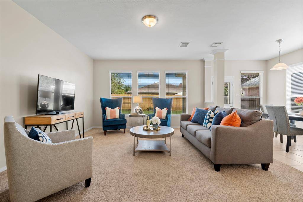 Family room with large windows making the room bright and enjoyable.