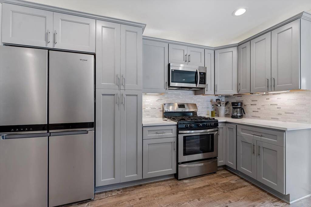 With abundant cabinetry, generous storage, and sleek stainless steel appliances, this kitchen is as functional as it is stylish.