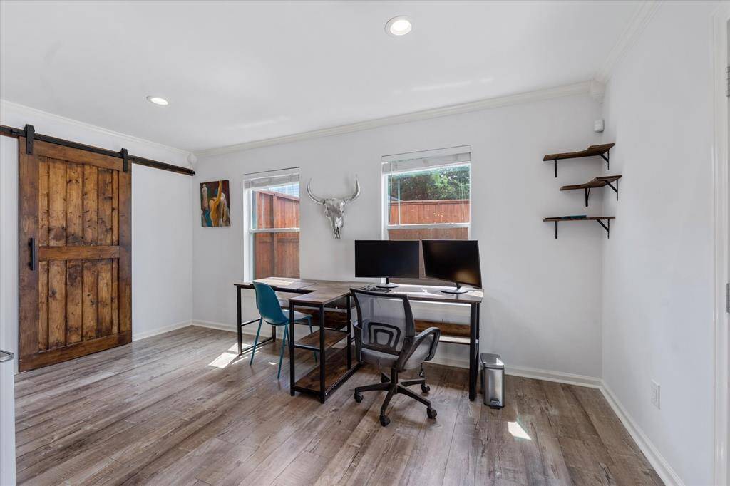 This bright, window-lined space can easily serve as a dedicated home office, cozy breakfast nook, or creative corner — tailored to fit your lifestyle.