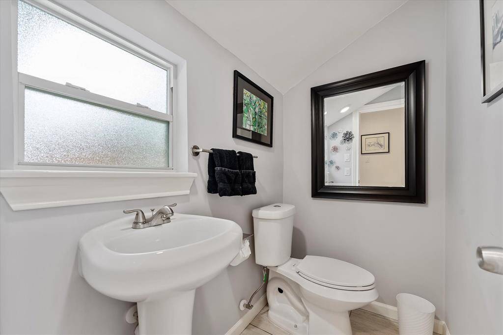 A conveniently located half bath sits just off the bonus space and near the patio door — ideal for guests and easy access from the backyard.