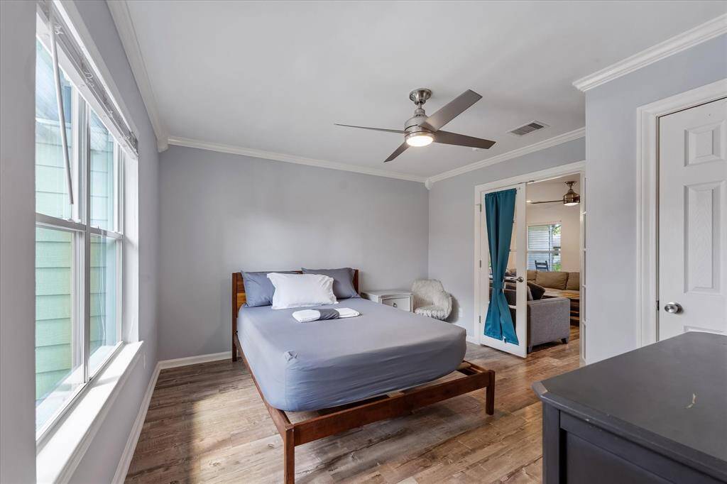 Another view of the guest suite, featuring elegant French doors, abundant natural light, and a private en-suite bathroom — perfect for guests or a stylish home office.