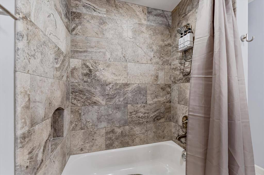 A spacious tub and large walk-in shower create a comfortable, functional setup