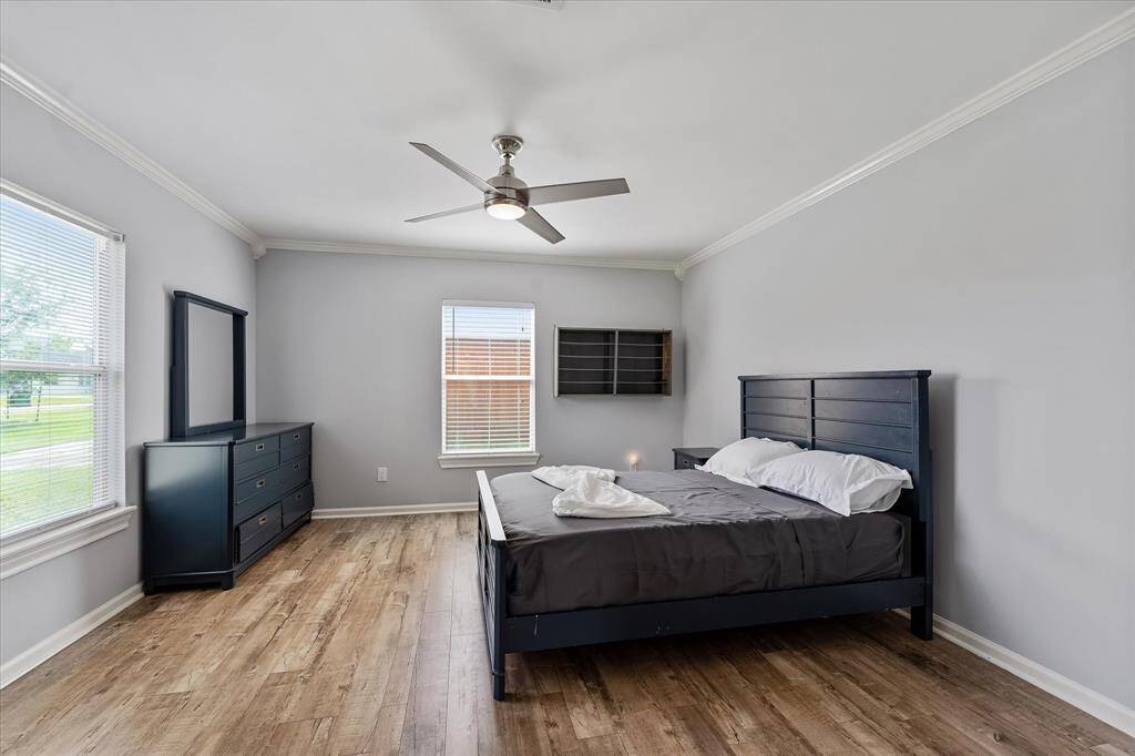 Another view of this light-filled bedroom, complete with custom closets — just like every room in the home, thoughtfully designed for storage and style.