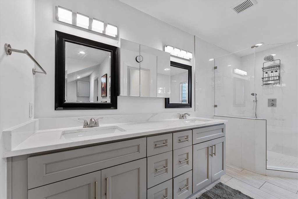 In the primary bathroom, you’ll find double sinks, a dedicated vanity area, a spacious walk-in shower, and a soaking tub — all designed to make everyday routines feel a little more luxurious.
