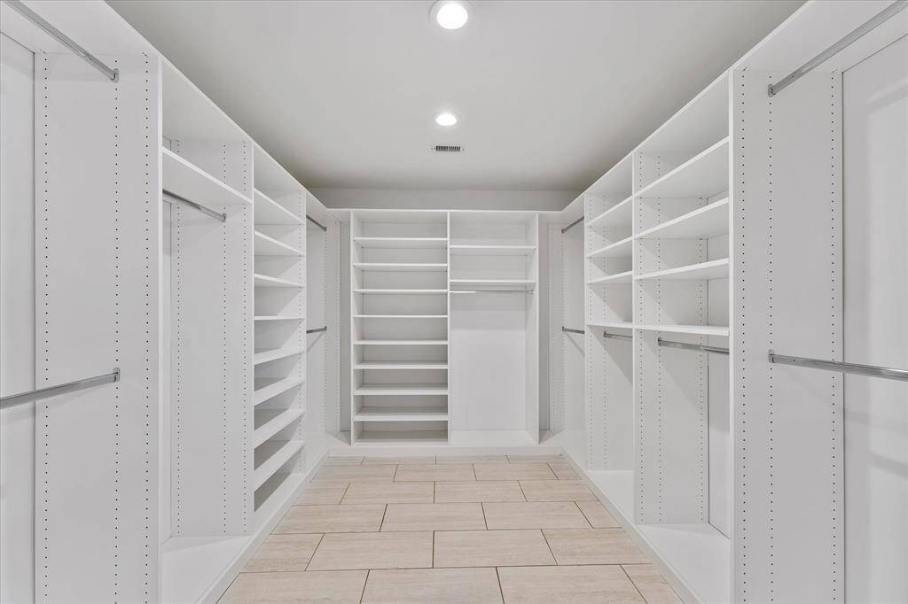 The kind of walk-in closet you dream about — custom-built with smart storage, clean lines, and plenty of space to keep everything effortlessly organized.