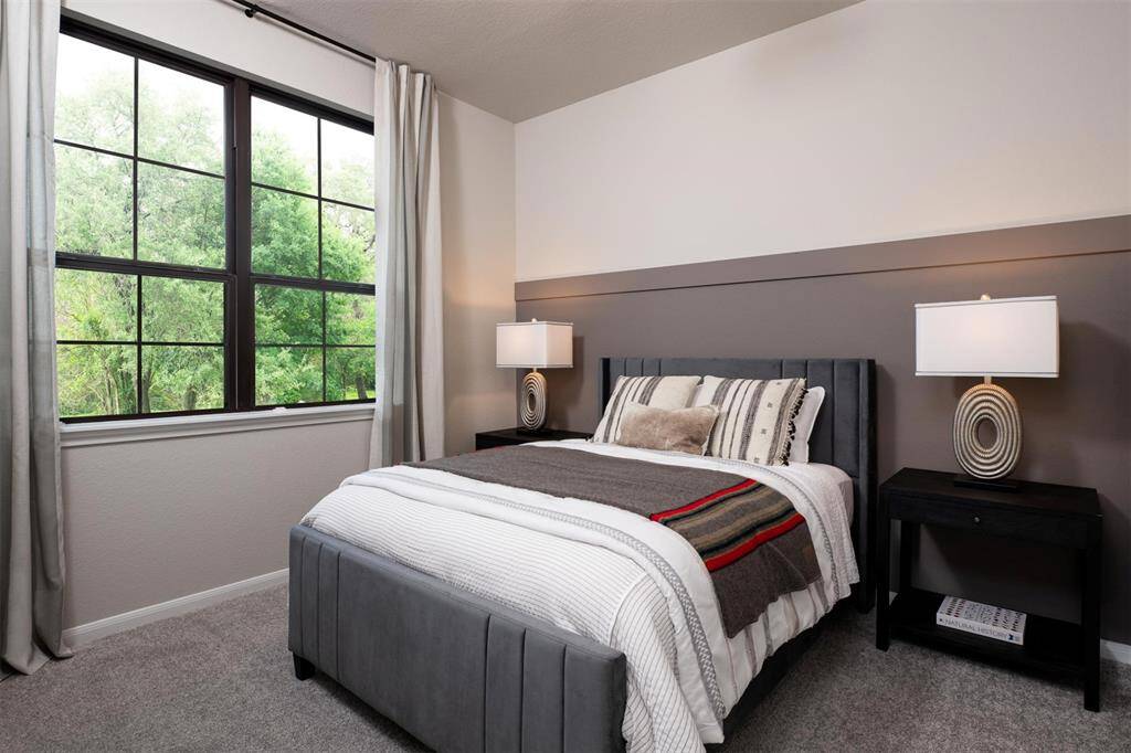 Your secondary bedroom features plush carpet, fresh paint, closet, and a large window that lets in plenty of natural lighting.