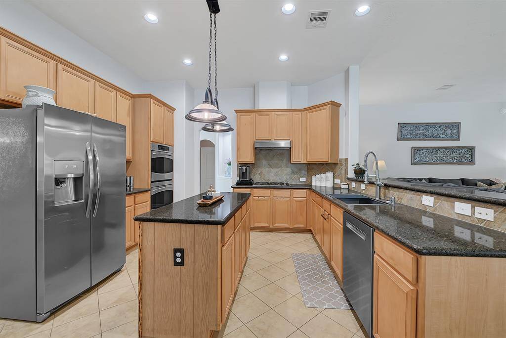 Anther view of the kitchen area and workable island. Plenty of room for the family to gather!