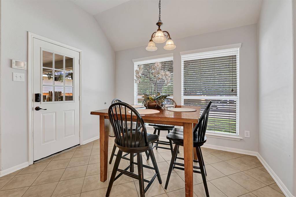 Nicely sized breakfast area with vaulted ceilings, bathed in natural light.