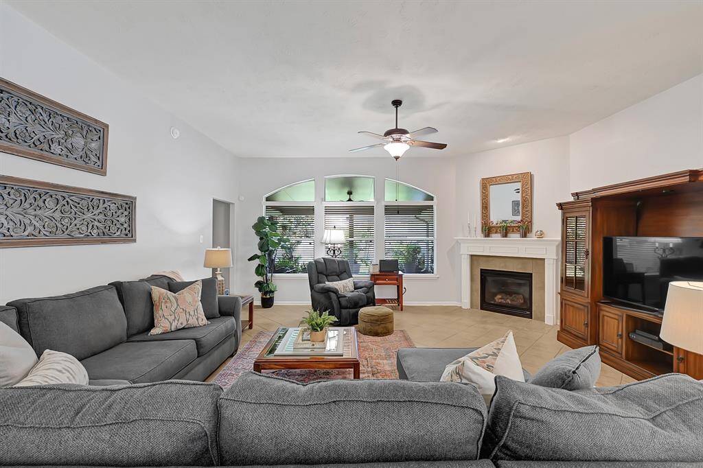 Charming and nicely sized living room with lovely windows framing out the beautiful backyard.