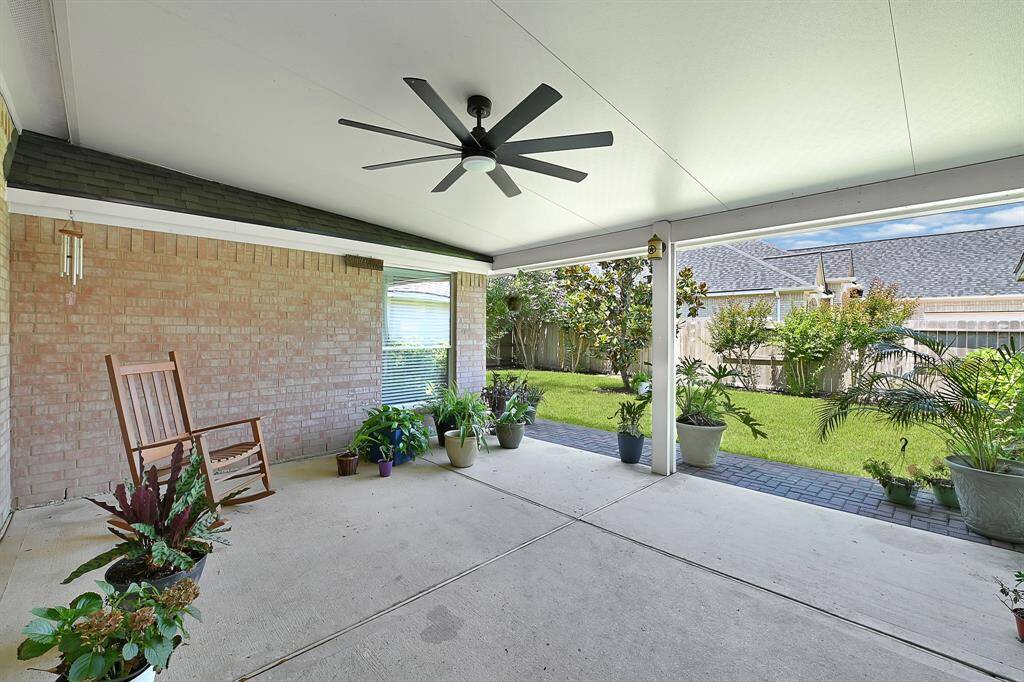 This lovely covered space is the perfect place to grab some shade, while having coffee and admiring the well cared for backyard.