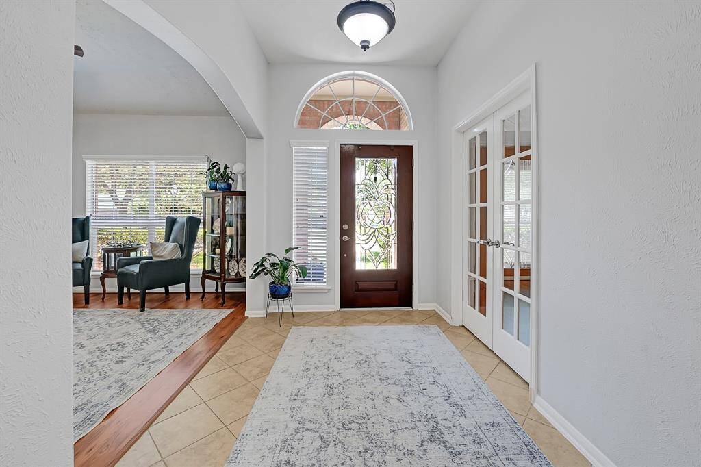 Entryway is bathed in beautiful natural light, fresh paint, formal living and study as you arrive.