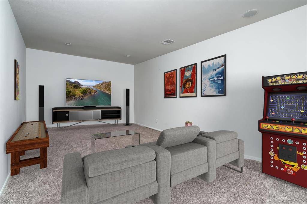 Enjoy movie nights in the cozy home theater, complete with plush carpet and subtle recessed lighting for the perfect ambiance. *Virtually Staged*