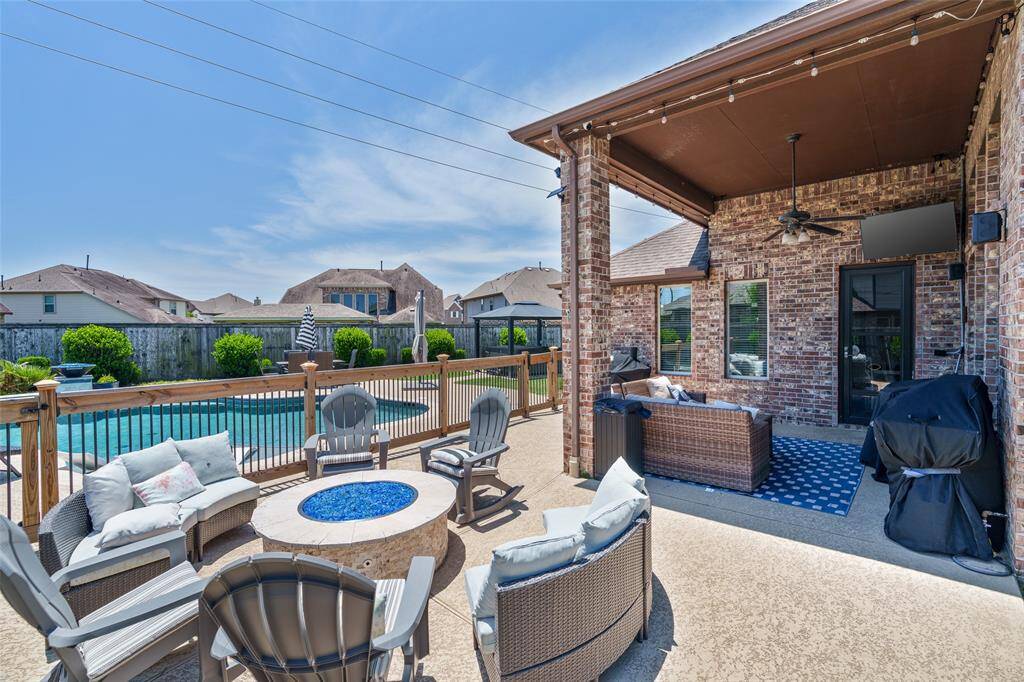 Don't forget to step into the backyard retreat—complete with a covered patio, sparkling in-ground pool, and relaxing hot tub, perfect for year-round enjoyment.