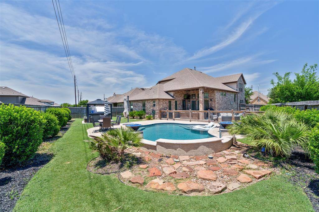 This gorgeous home offers the ultimate summer oasis with a sparkling pool—perfect for relaxing, entertaining, and making lasting memories.