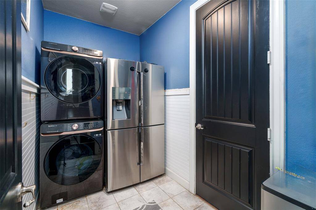 This laundry room is perfect for a stacked washer/dryer set and an extra fridge.