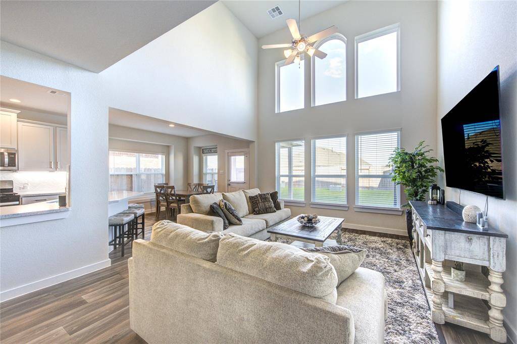 Large windows in the living room provide a lot of natural light with a view of the moon at night