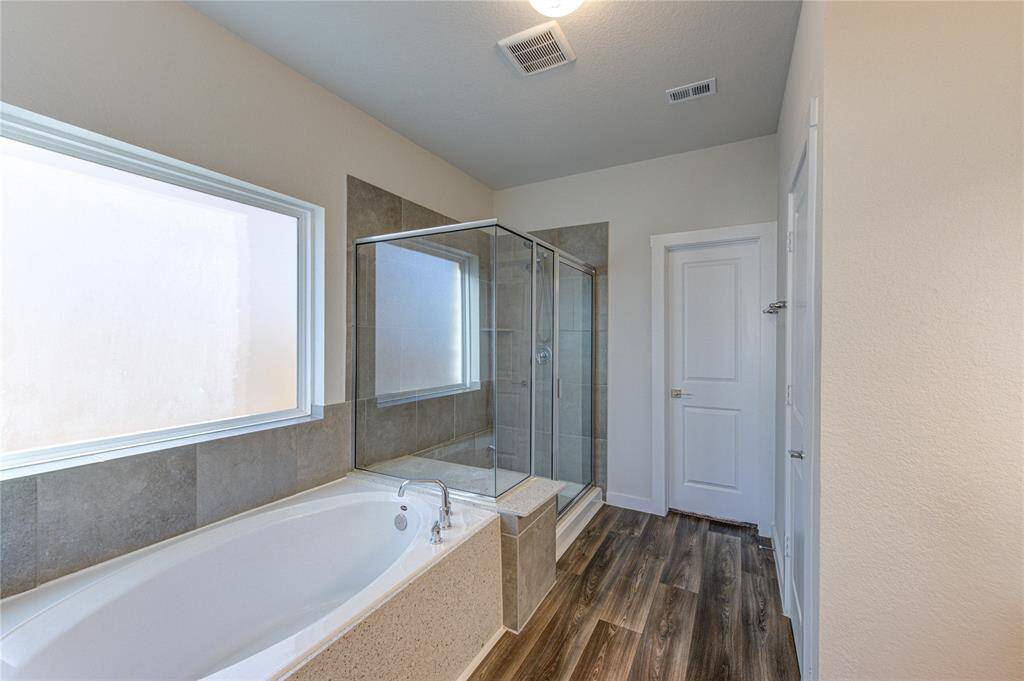 Large walk in shower with bench and soaking tub