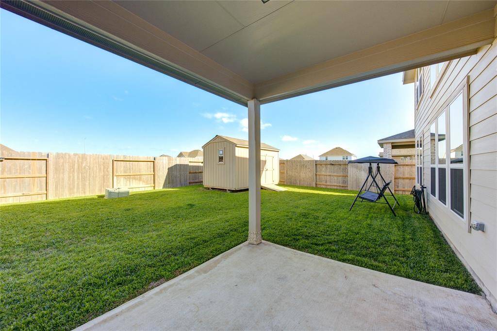 Covered patio with a shaded yard every afternoon