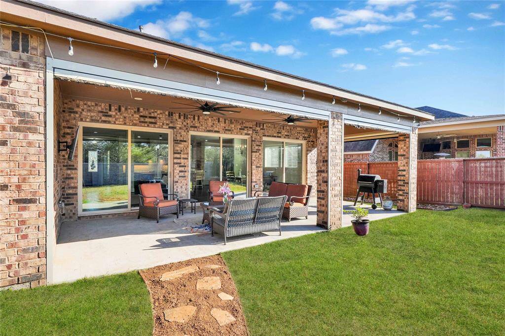 Extended covered patio with additional pull down shades and fans