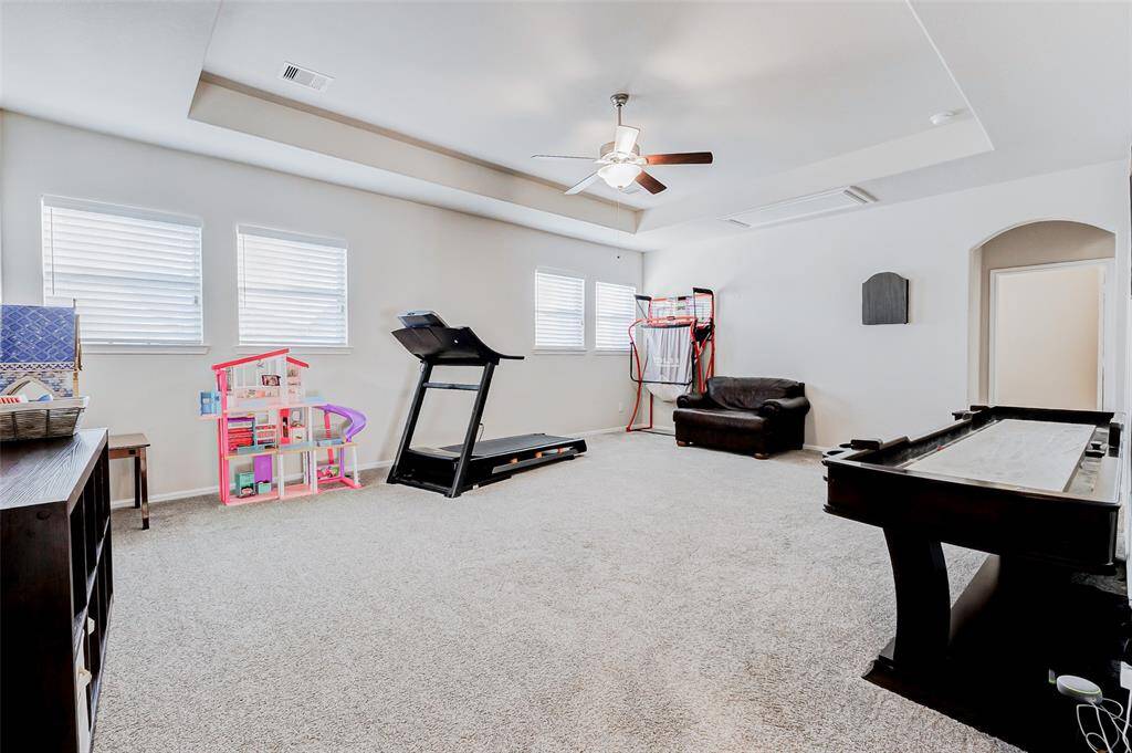 This spectacular game room isbathed in natural light from fourexpansive windows and featuresan elegant tray ceiling. A ceilingfan enhances the airy ambiancewhile providing optimal aircirculation, making it the perfectspace for fun and relaxation.