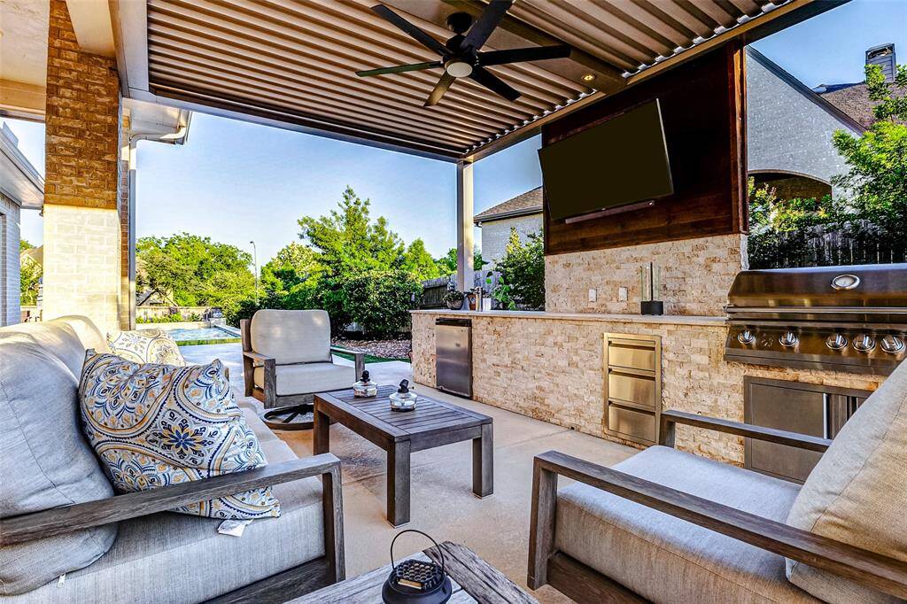 Step outside to your own private retreat—an ideal space to relax and unwind. The sparkling pool, built-in outdoor kitchen, and motorized pergola, all added in Spring 2019, create a seamless blend of comfort, luxury, and functionality for outdoor living.