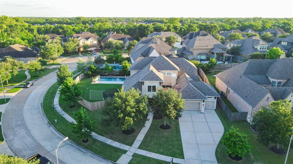 Perched on an expansive corner lot, this residence offers an impressive outdoor retreat complete with a sparkling pool and spa, an extended covered patio, and a fully equipped outdoor kitchen—perfect for refined entertaining. Ample greenspace provides a serene backdrop and room to roam.