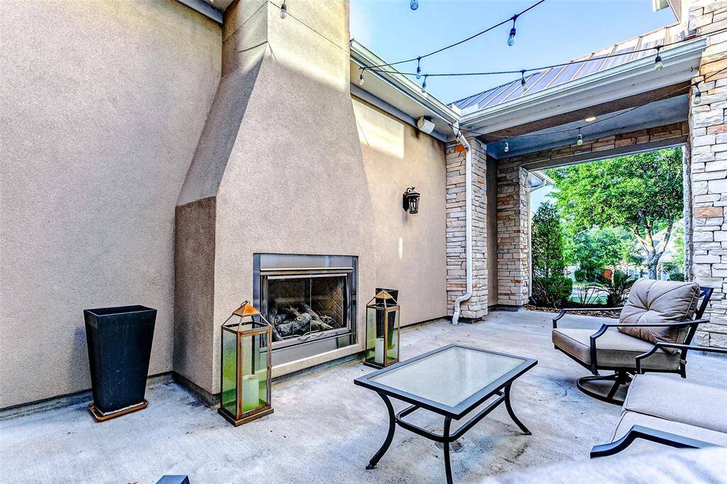 Ideal for morning coffee, evening wine, or intimate gatherings, this thoughtfully designed space enhances natural light, promotes fresh air flow, and creates a seamless connection between indoor and outdoor living. This space comes complete with a fireplace that subtly echoes the home’s exterior stucco.