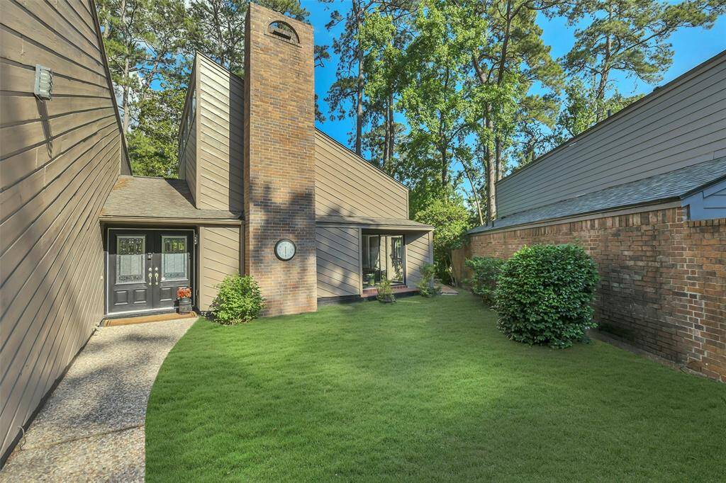 When you enter the gated entrance off the driveway you have a patio area - currently this area is fully mulched - this is VIRTUALLY staged with grass to show how you could plant grass for your pets to roam here.