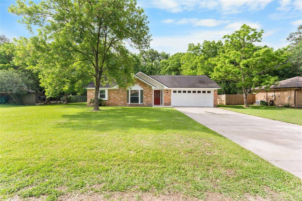Beautifully maintained single-story home with expansive front lawn and mature trees.