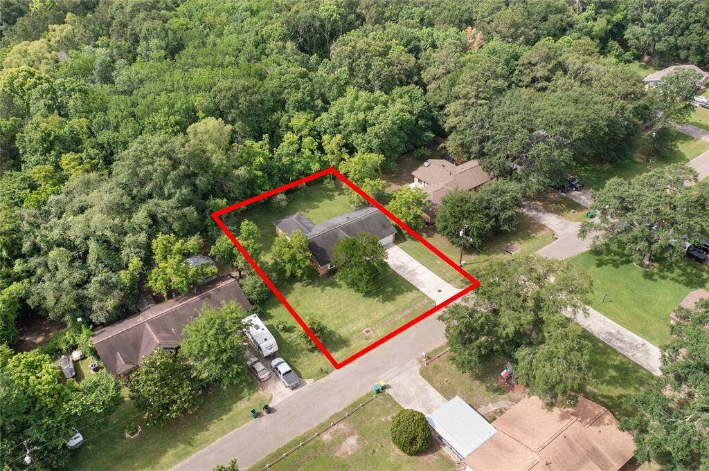 Overhead shot showcasing the spacious lot and surrounding greenery.