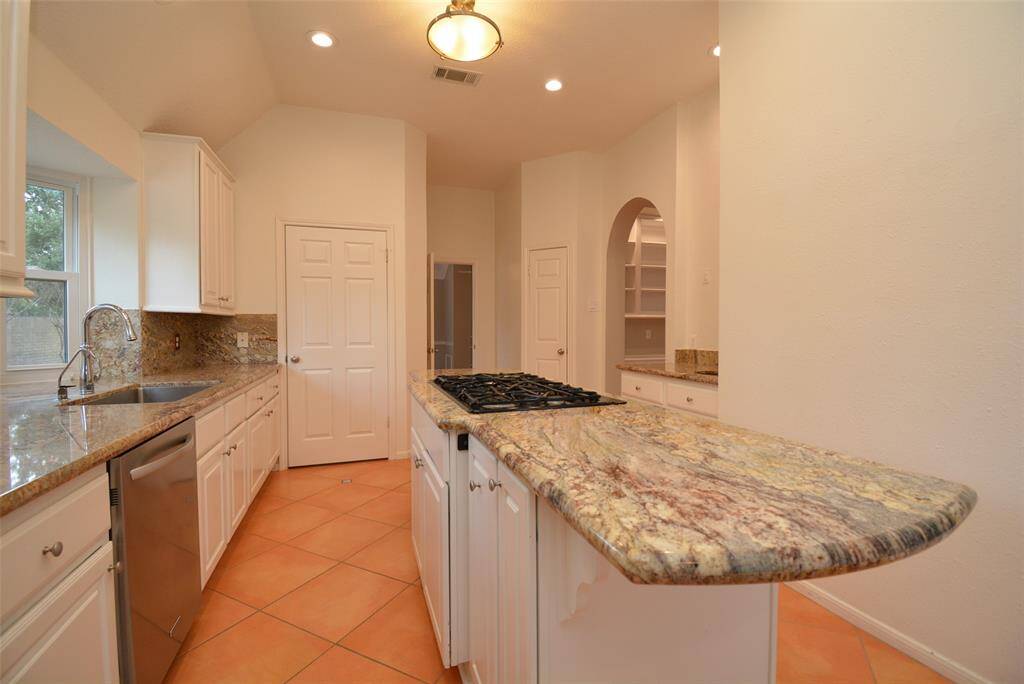 Large island with spice pull out rack, chopping boards compartment and pots and pans cabinet.