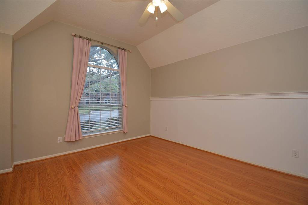 Secondary bedroom also features wainscoting